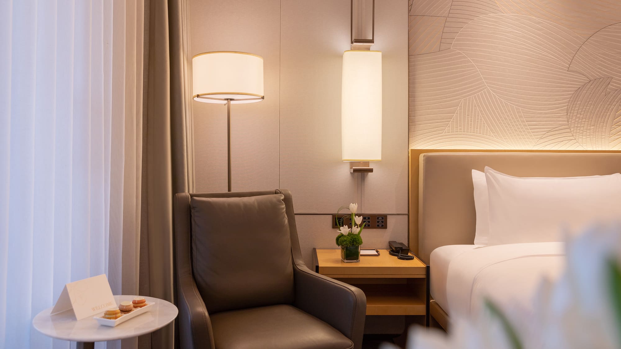 a chair next to a bed