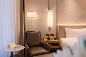 a chair next to a bed