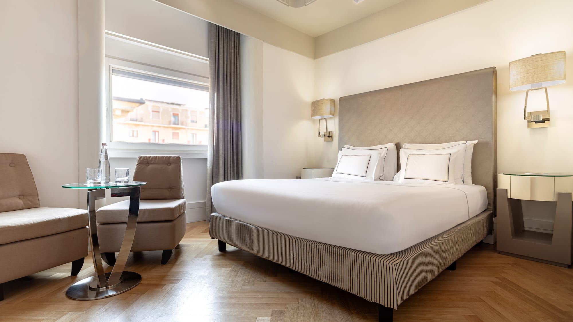 a bedroom with a bed and a chair