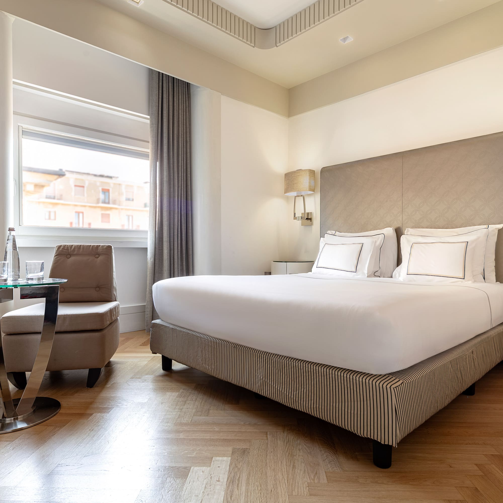 a bedroom with a bed and a chair