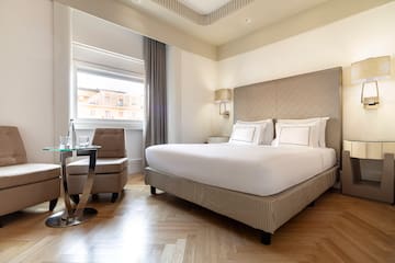 a bedroom with a bed and a chair