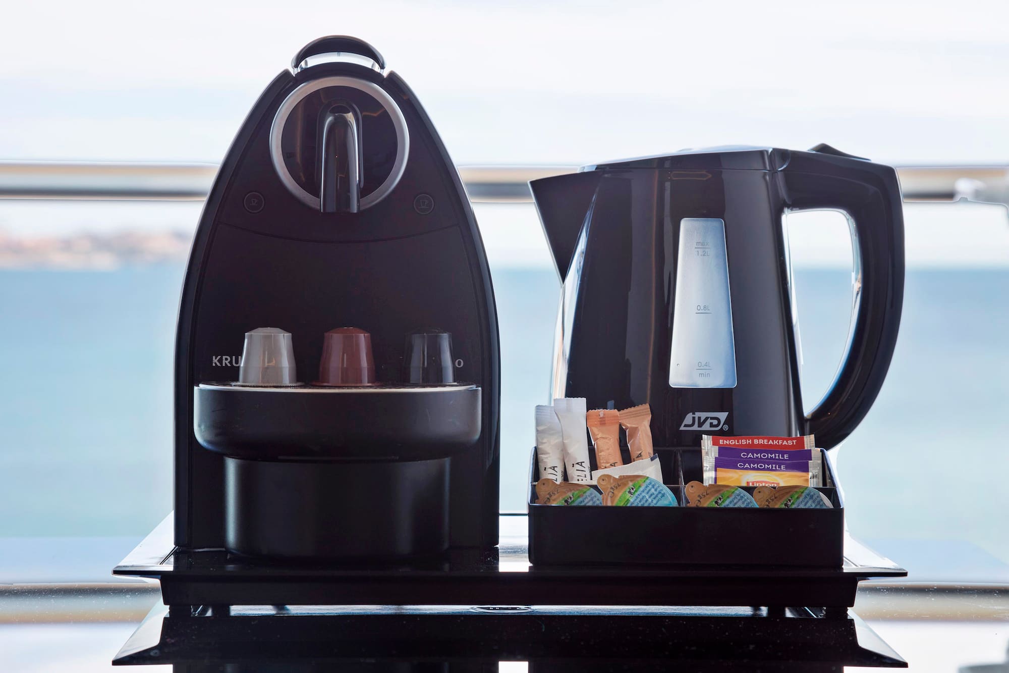 a coffee maker and a container of food
