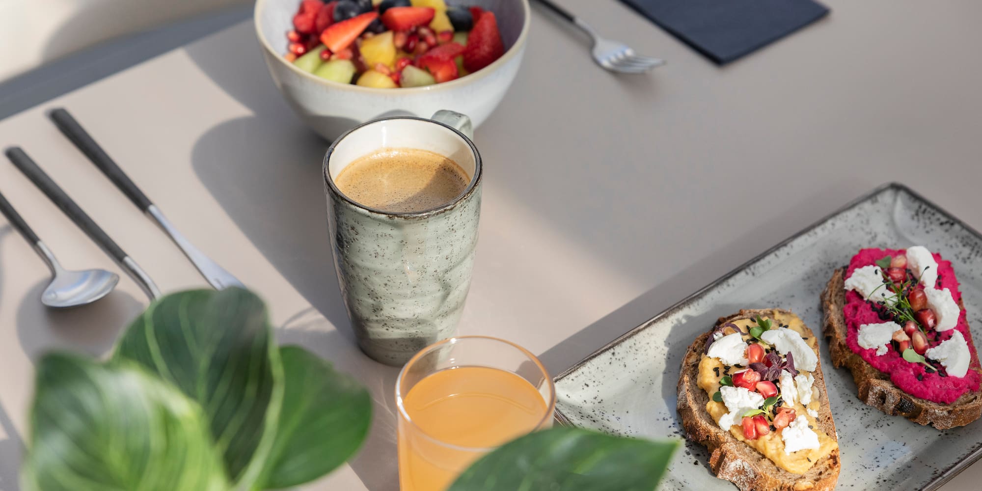 a plate of food and a cup of coffee on a table