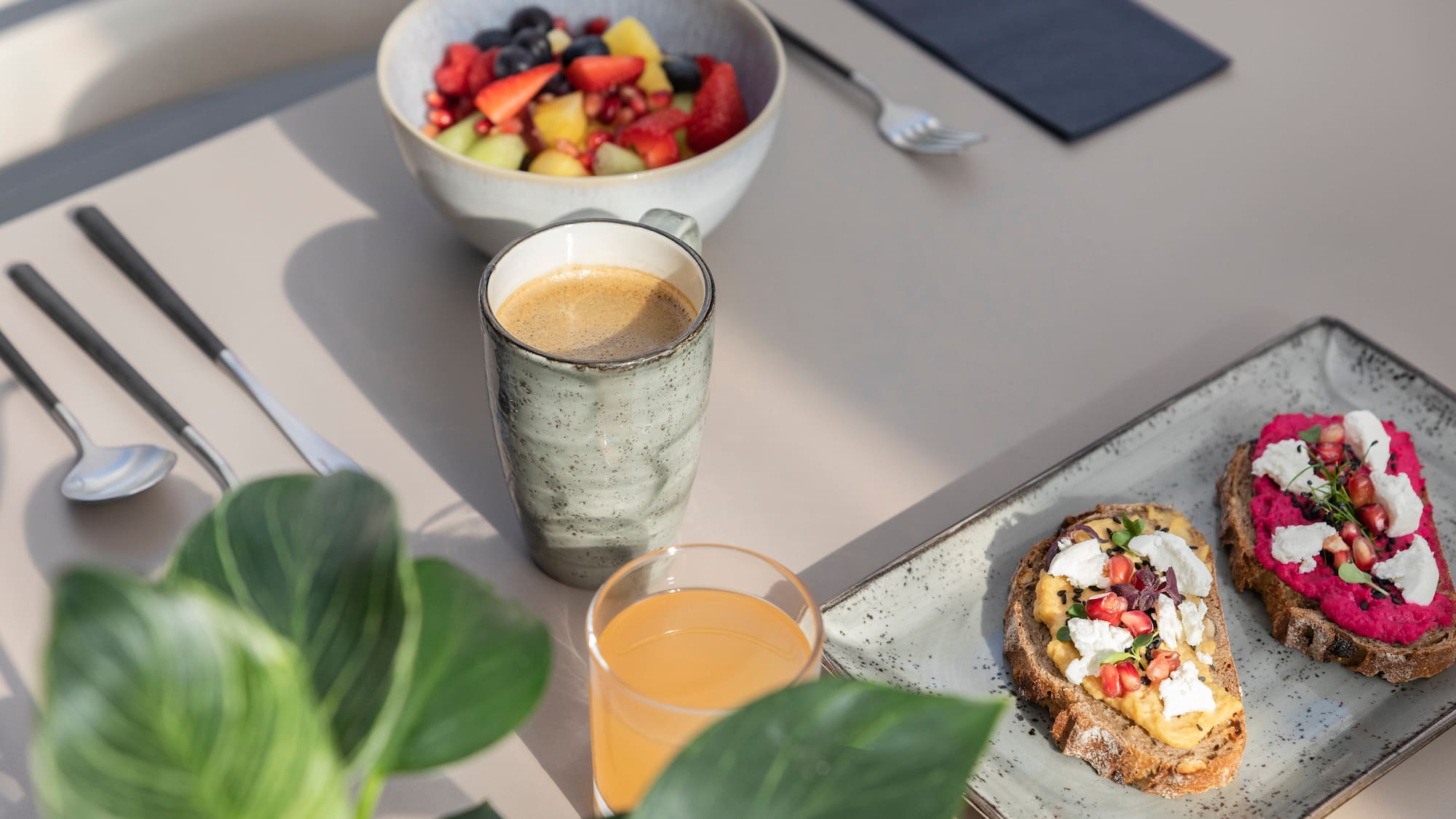 a plate of food and a cup of coffee on a table