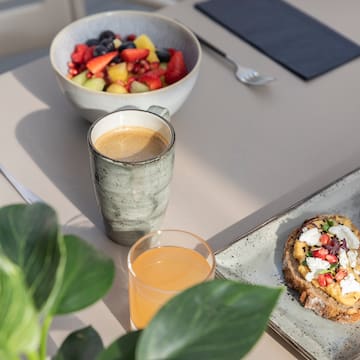 a plate of food and a cup of coffee on a table