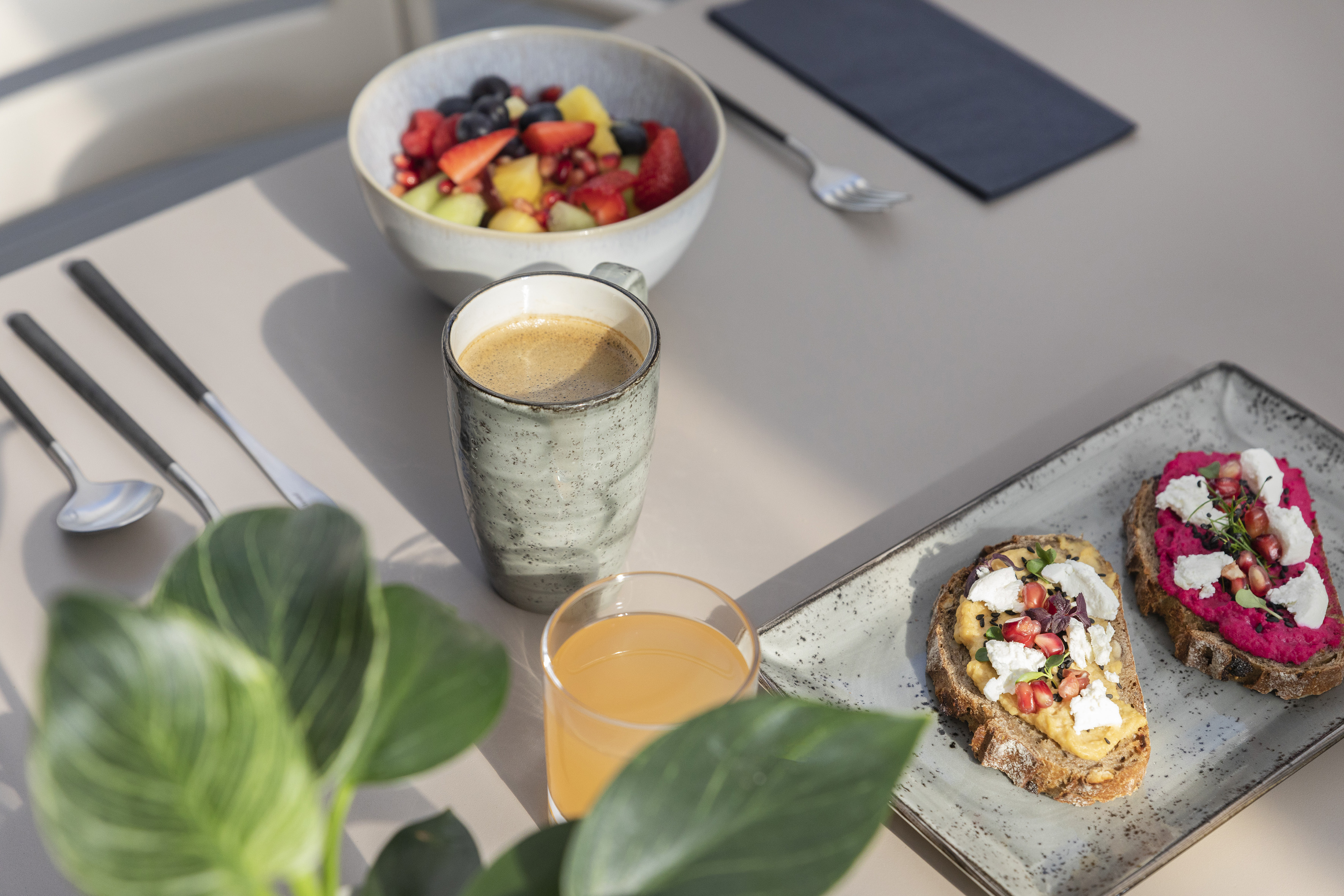 a plate of food and a cup of coffee on a table