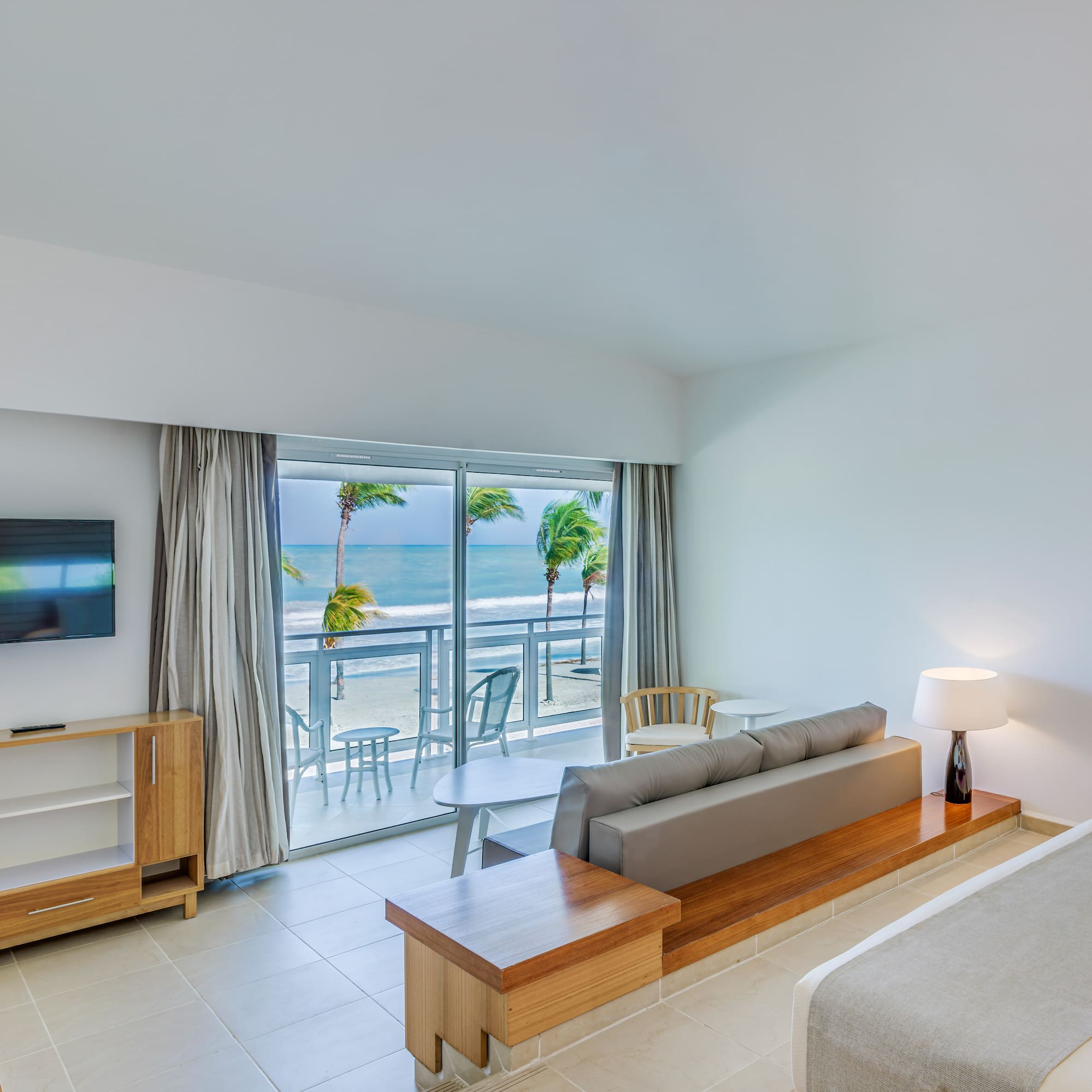 a room with a bed and a television and a table