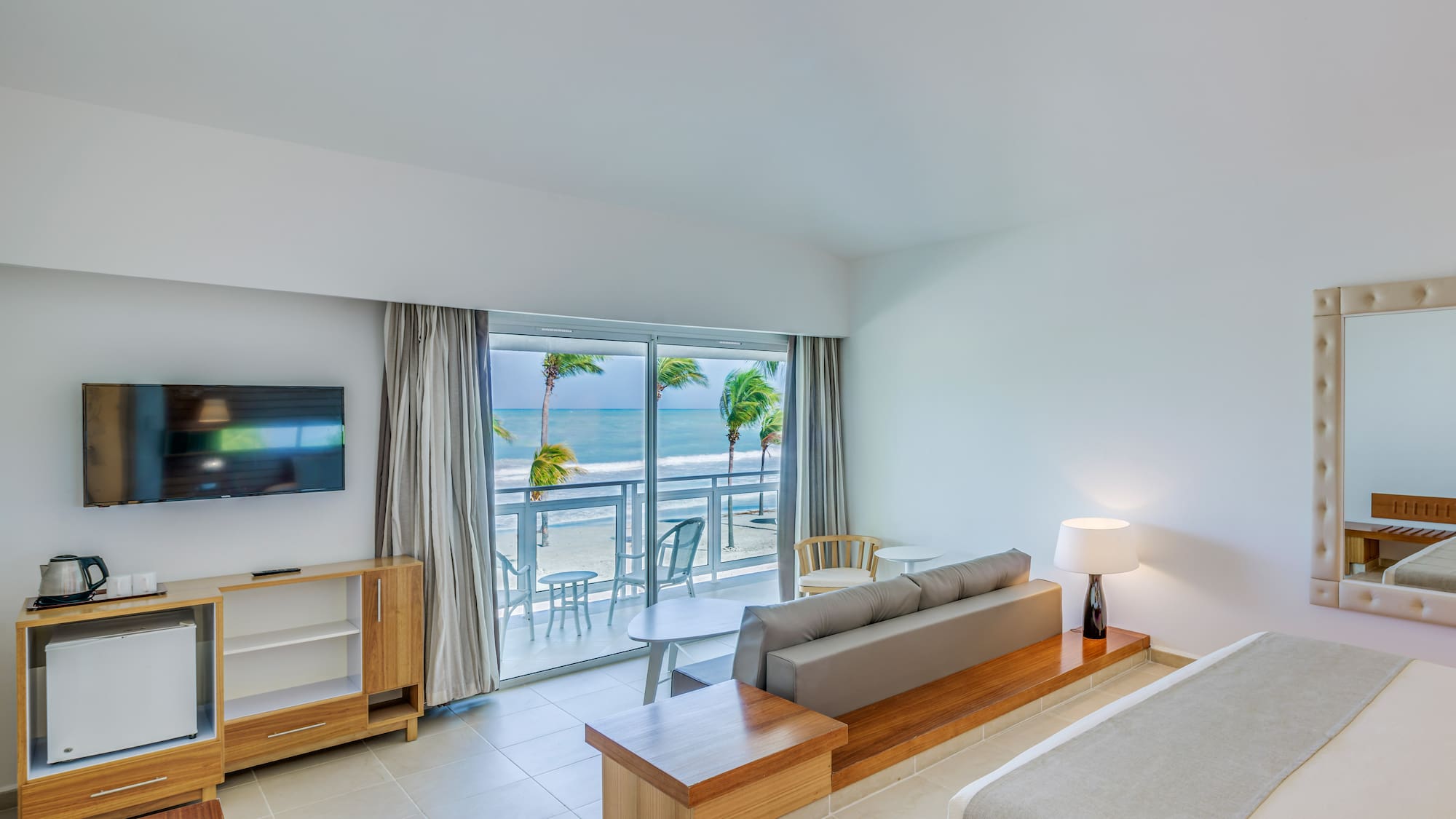 a room with a bed and a television and a table