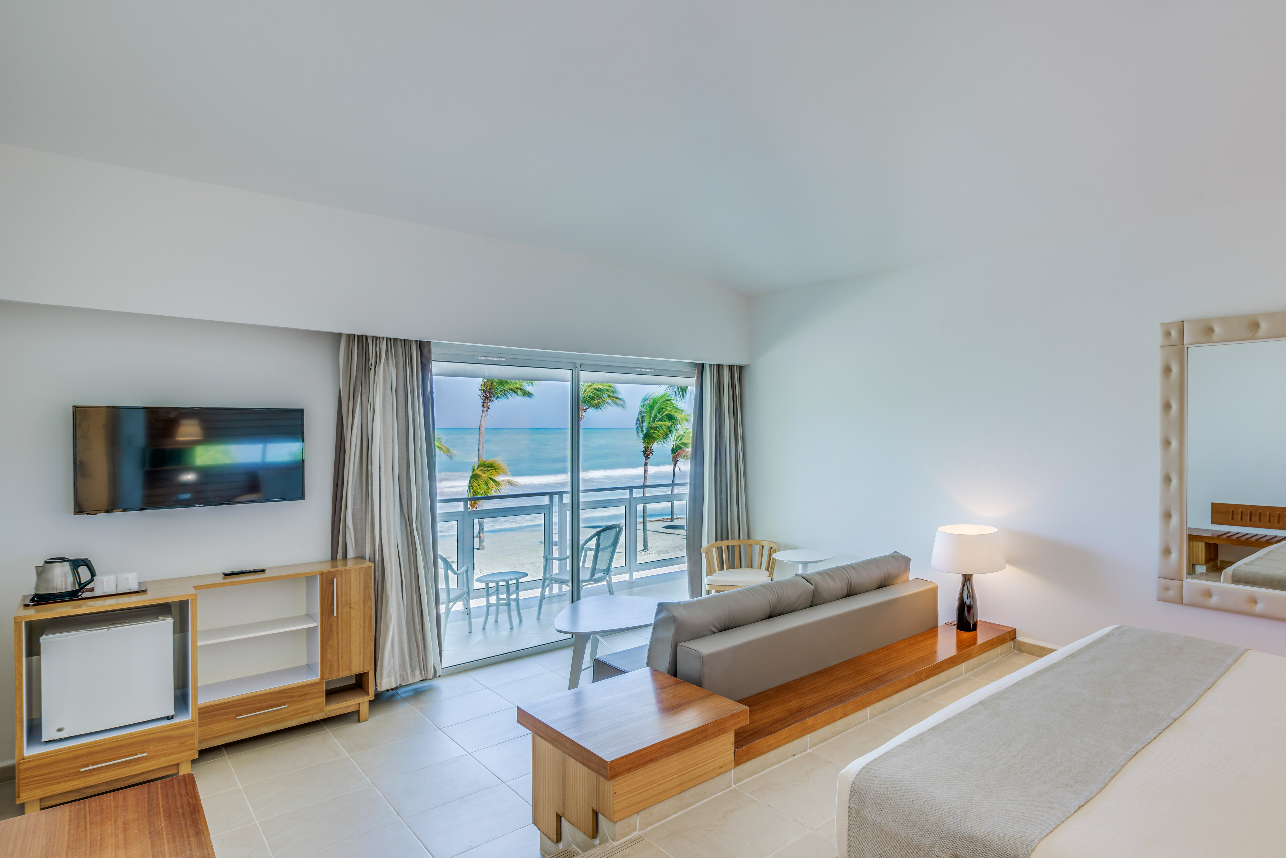 a room with a bed and a television and a table