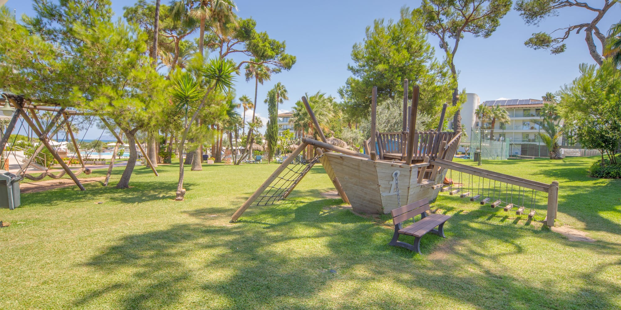 a playground with a wooden ship in the middle of a park