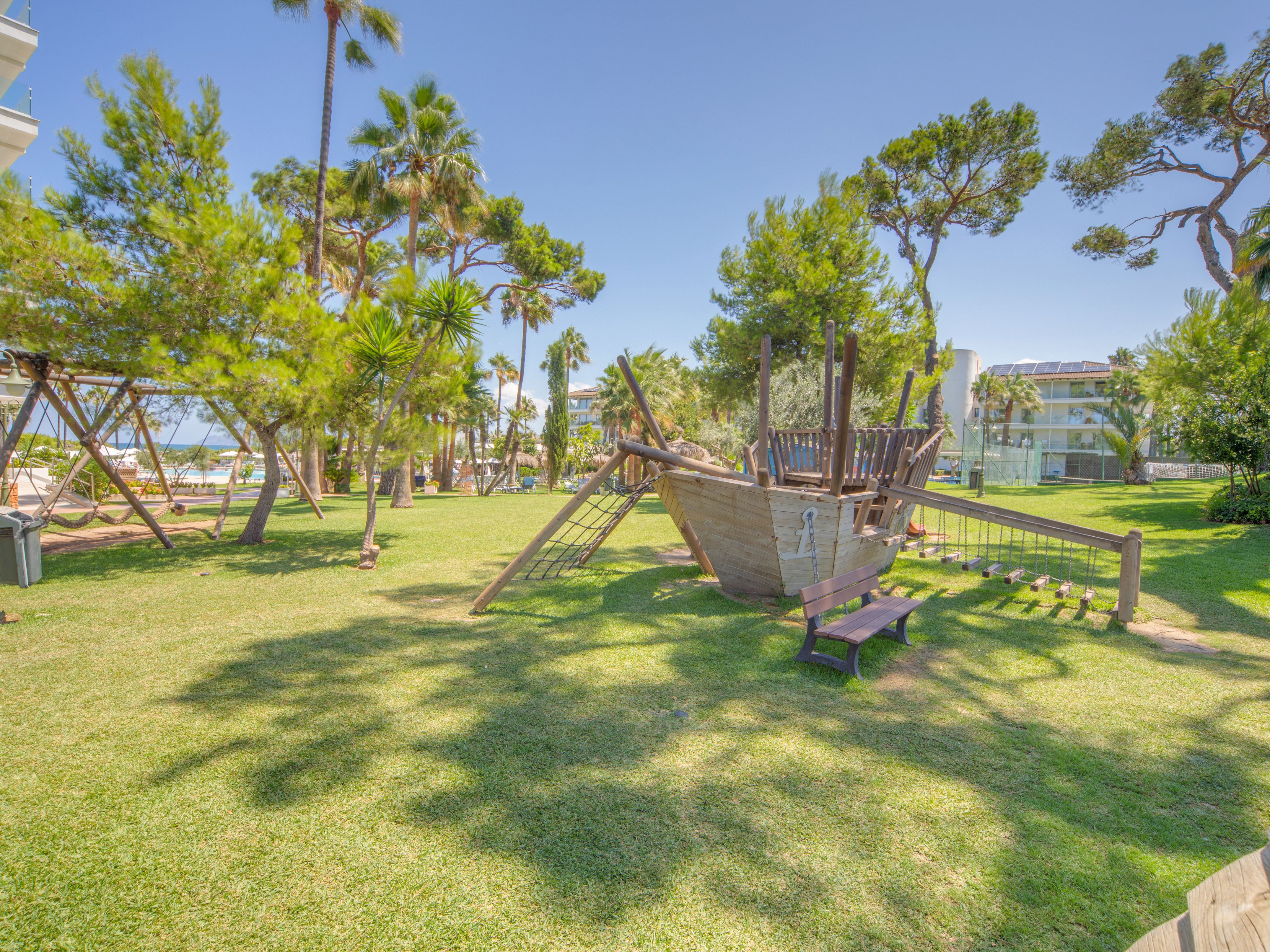 a playground with a wooden ship in the middle of a park