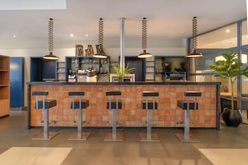 a bar with stools and lights