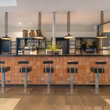a bar with stools and lights