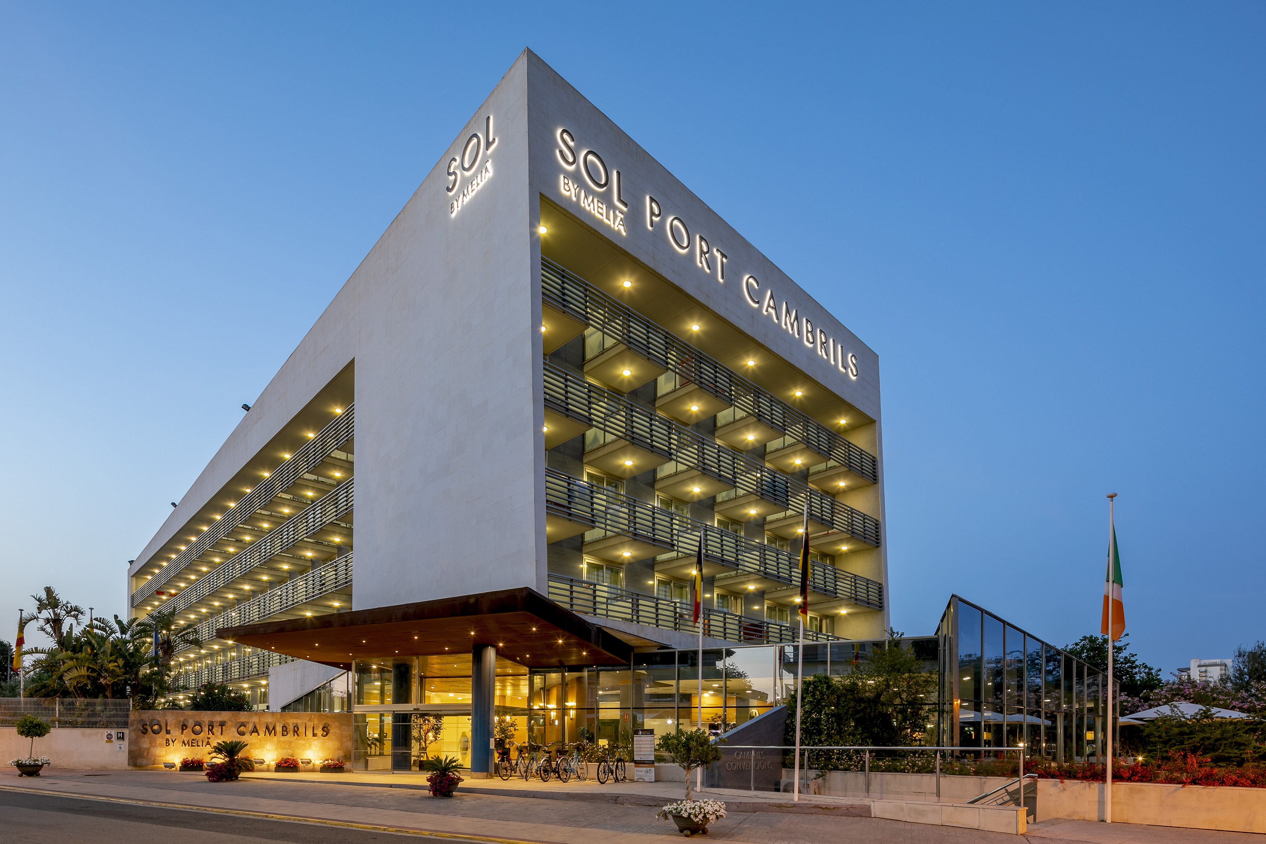 Sol Port Cambrils Meliá hotel exterior at dusk, with illuminated balconies.
