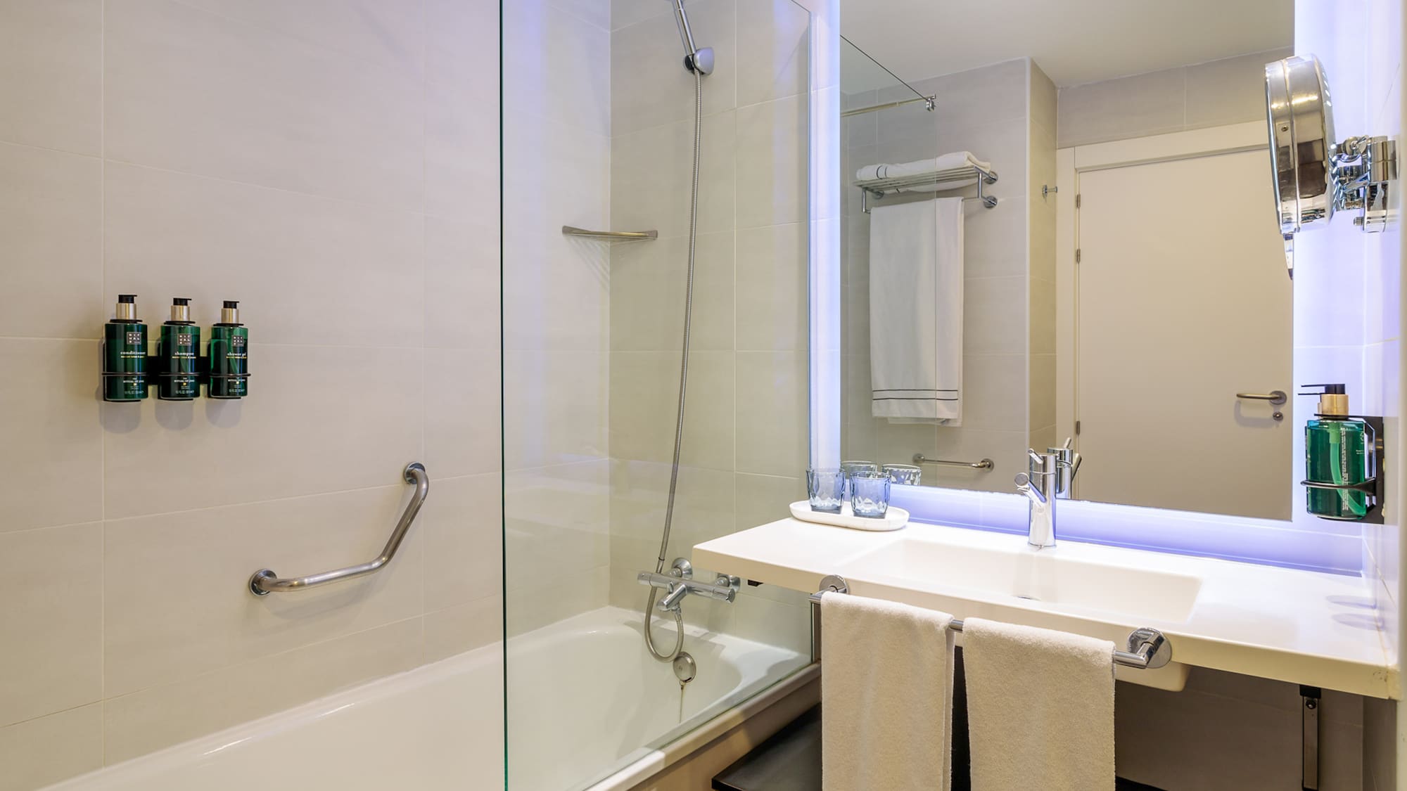 a bathroom with a glass shower and sink