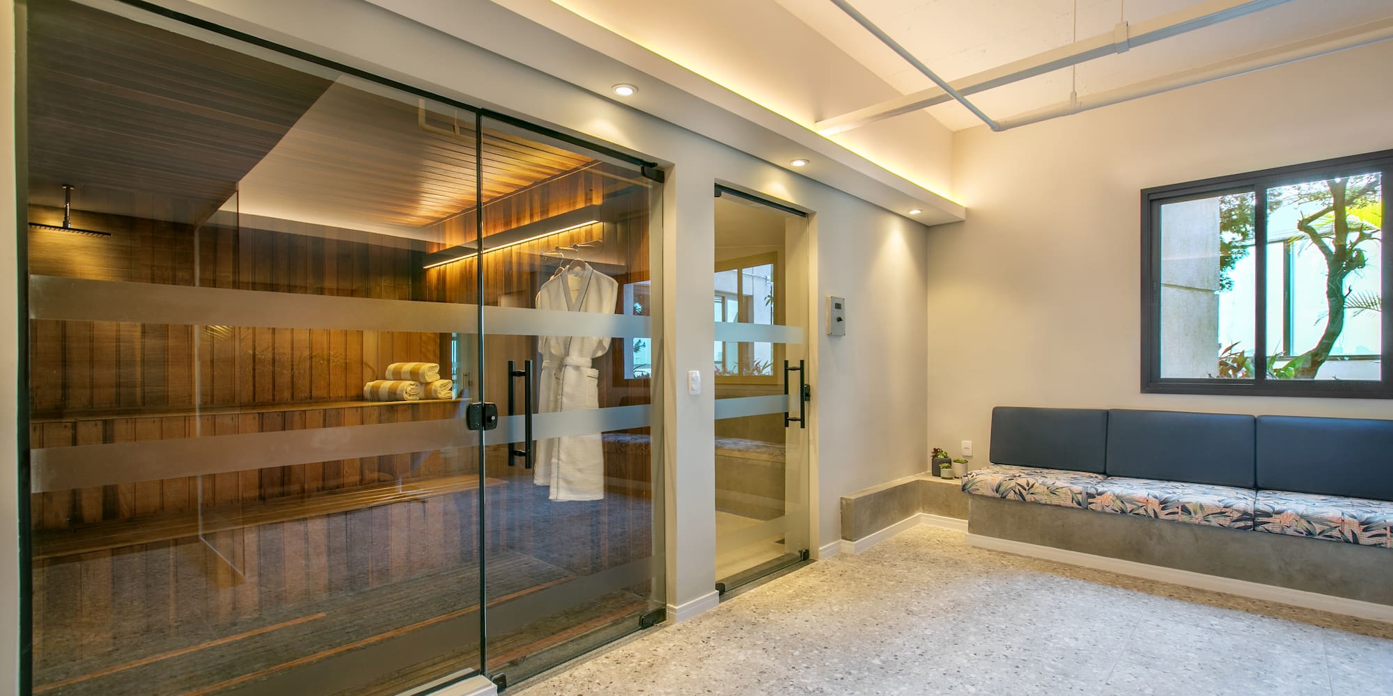 a room with glass doors and a bench