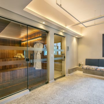 a room with glass doors and a bench