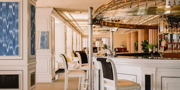 a bar with chairs and a round metal dome