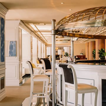 a bar with chairs and a round metal dome