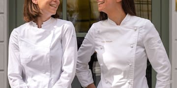 two women wearing white coats