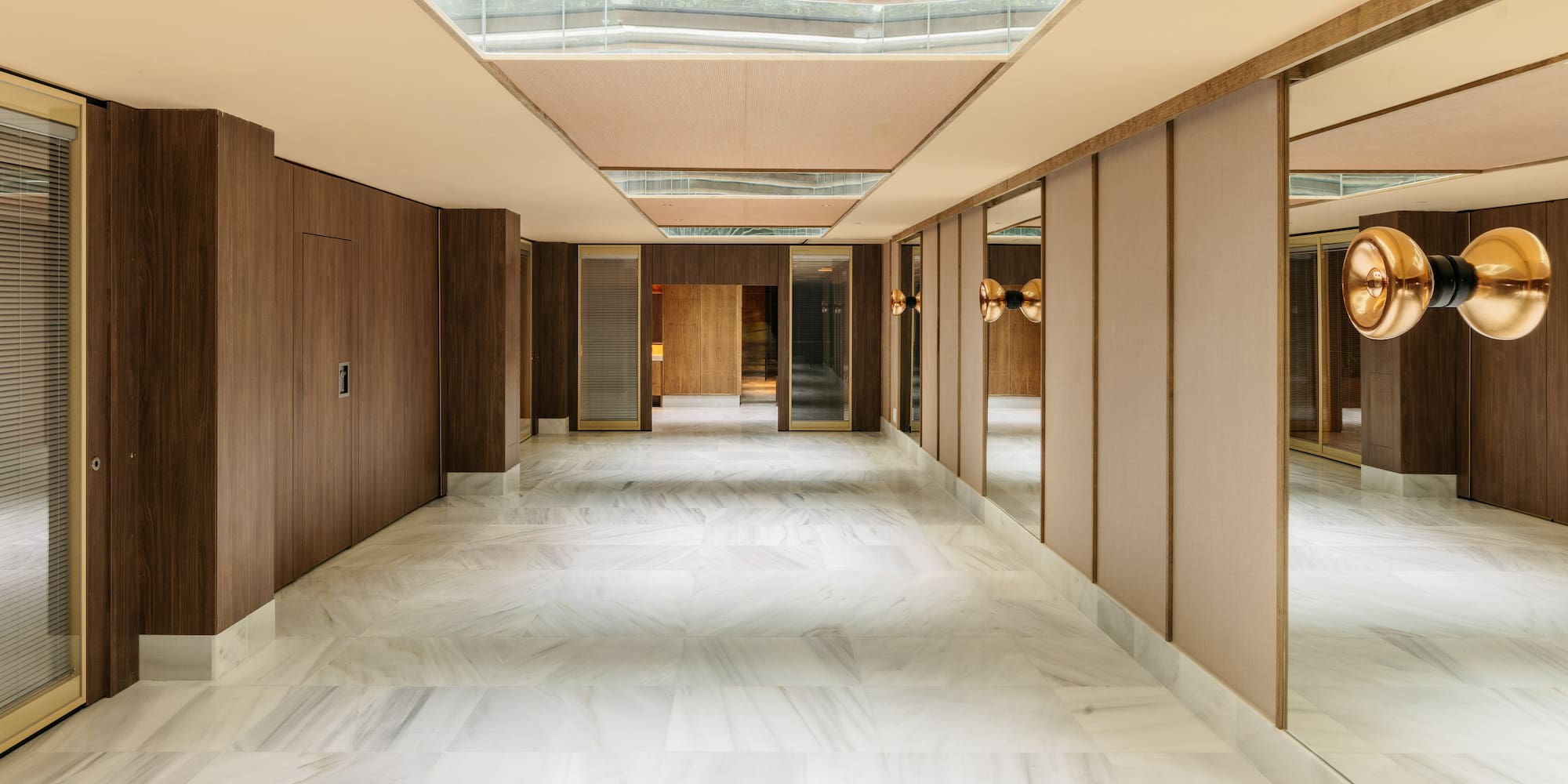 a hallway with mirrors and a glass ceiling