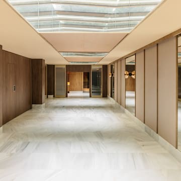 a hallway with mirrors and a glass ceiling