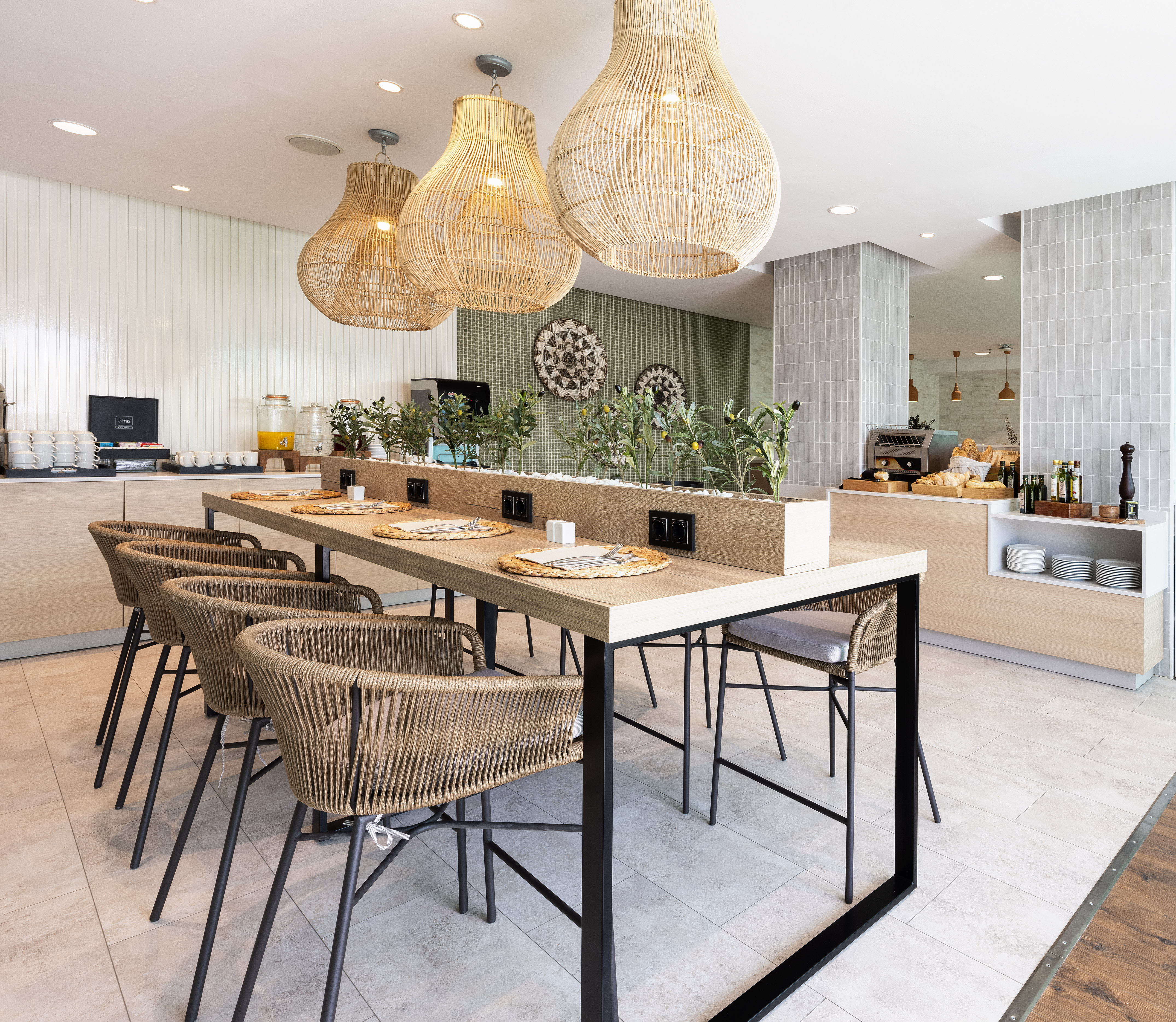 a dining table with chairs and a table with plates and a plant