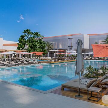 a swimming pool with lounge chairs and umbrellas