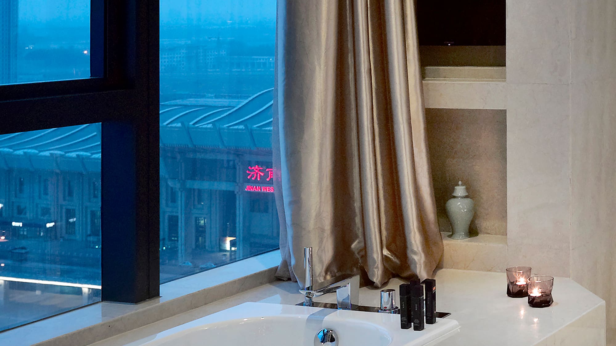 a bathtub with candles in a bathroom