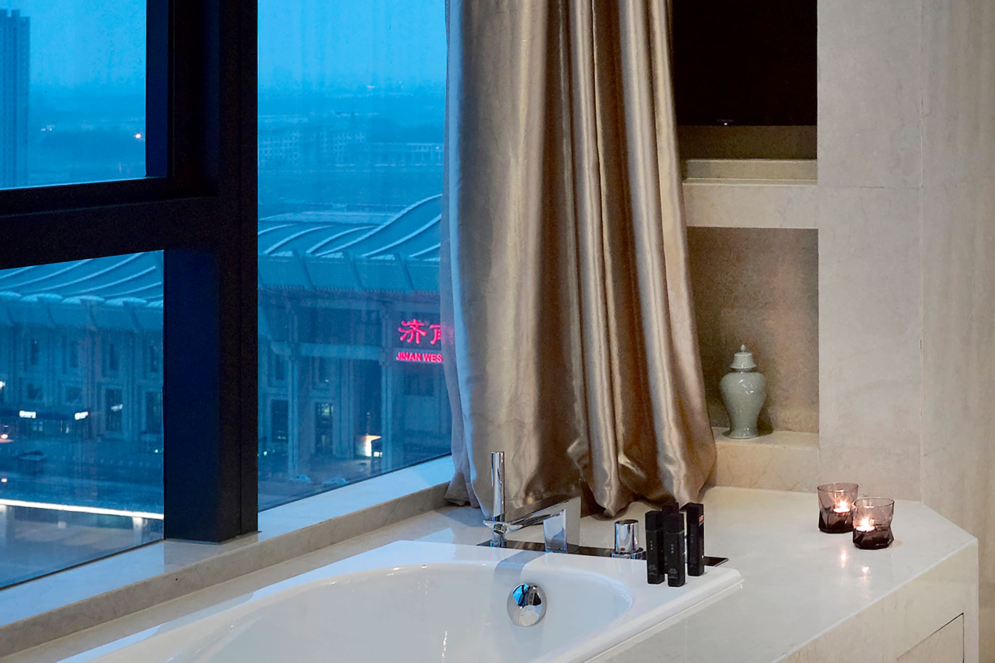 a bathtub with candles in a bathroom