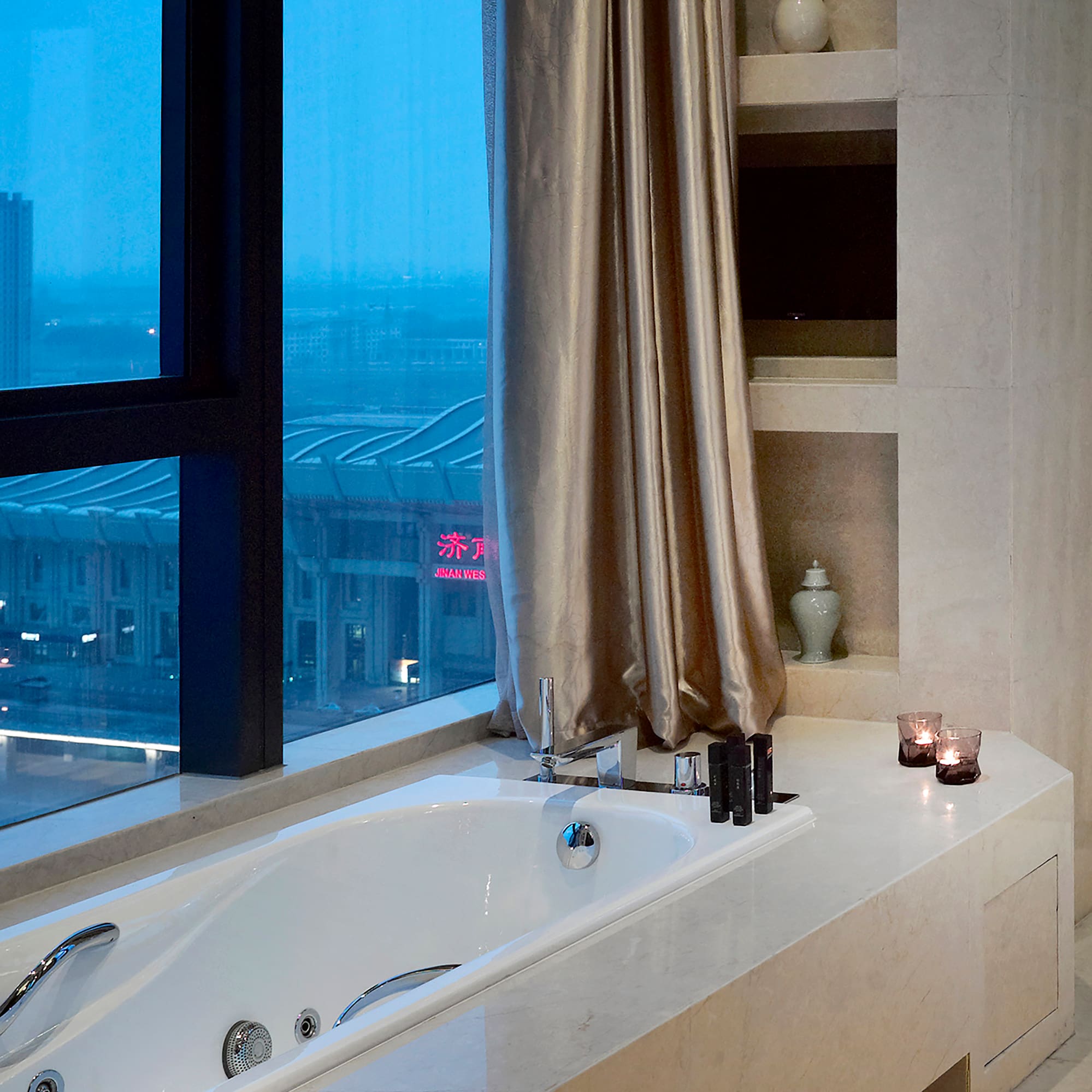 a bathtub with candles in a bathroom