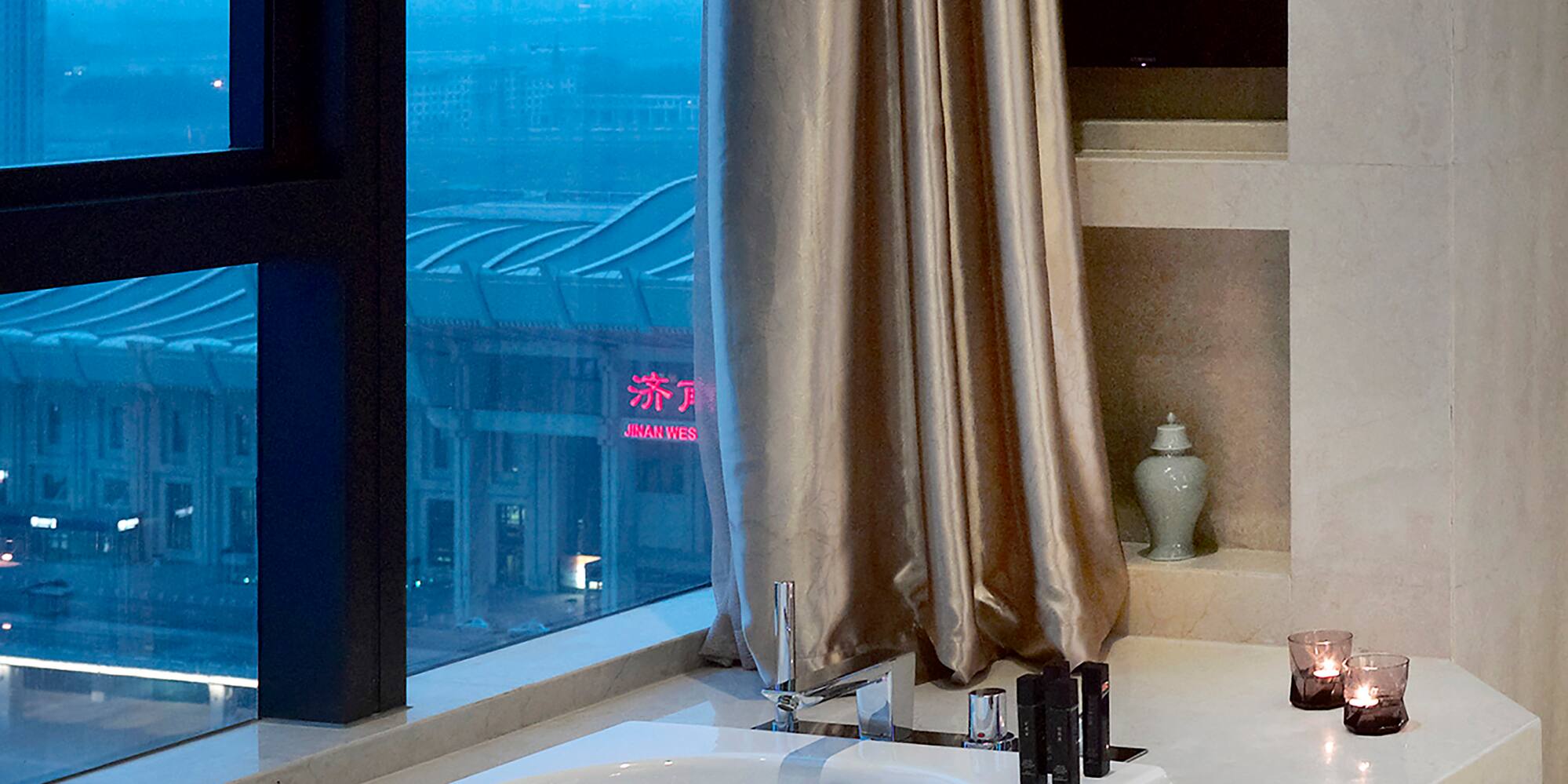 a bathtub with candles in a bathroom