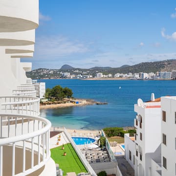 a view of a beach and buildings from a balcony.