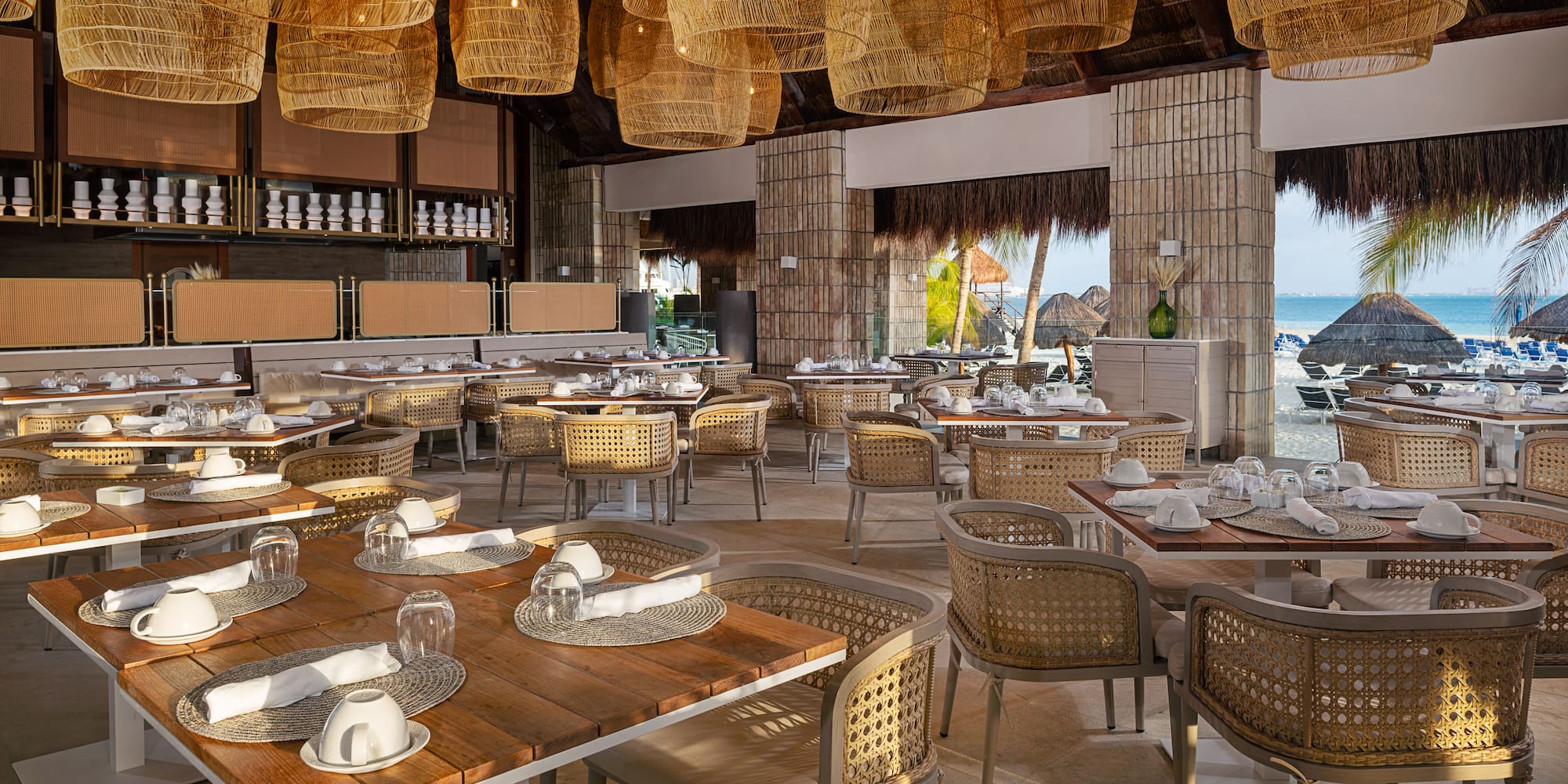 a restaurant with wicker chairs and tables