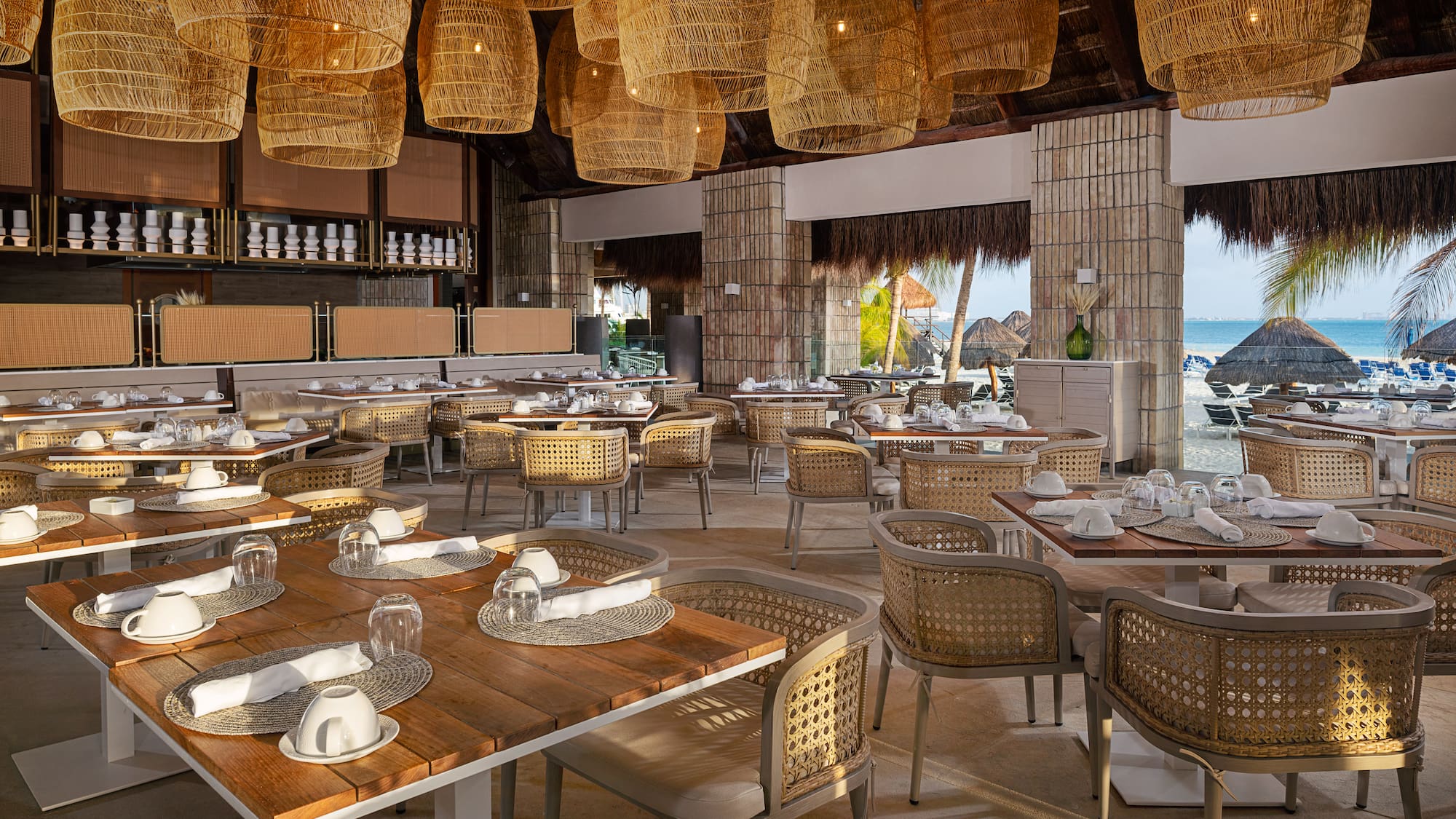 a restaurant with wicker chairs and tables