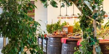 a wooden structure with barrels and a sign