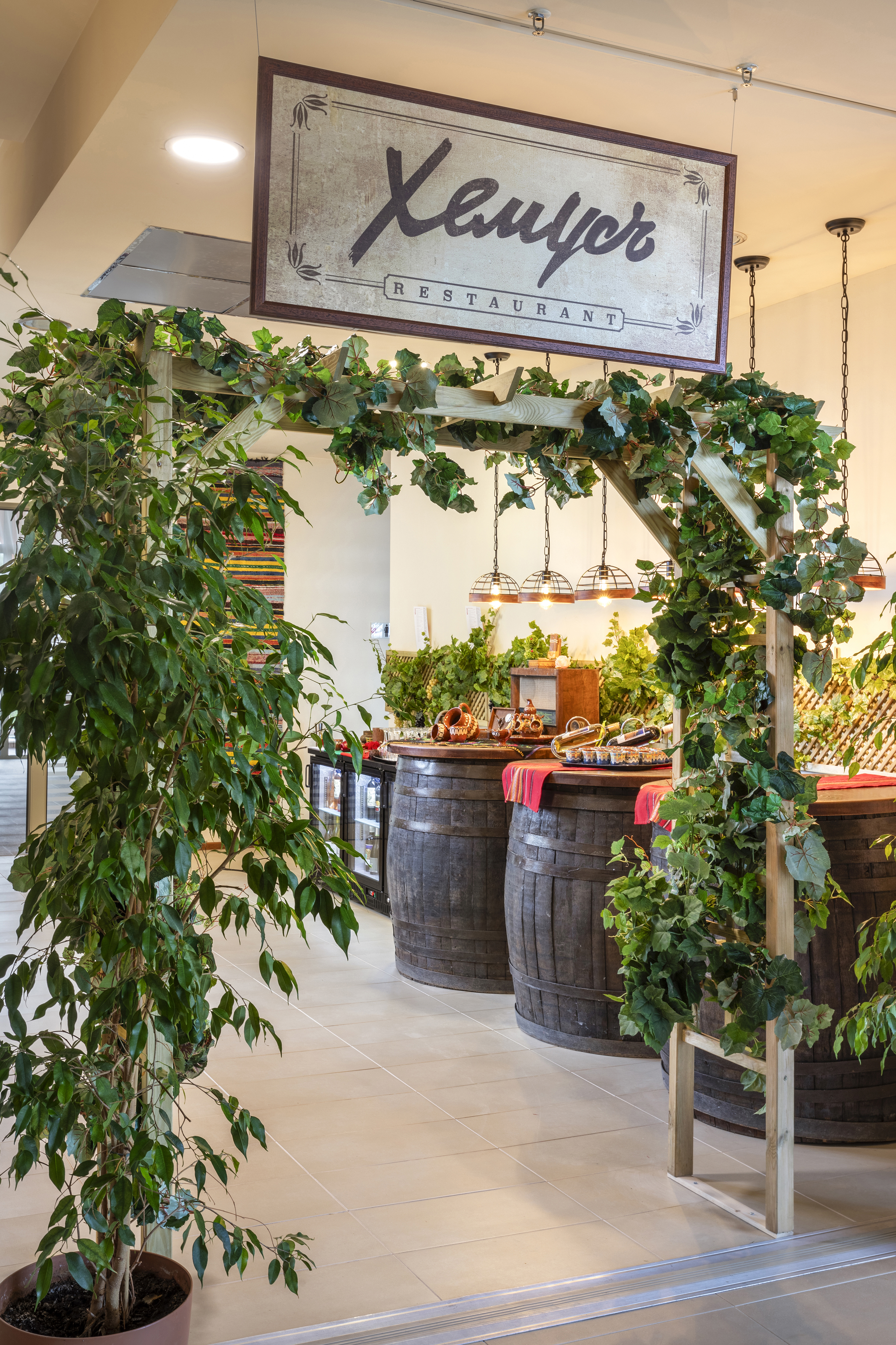 a wooden structure with barrels and a sign