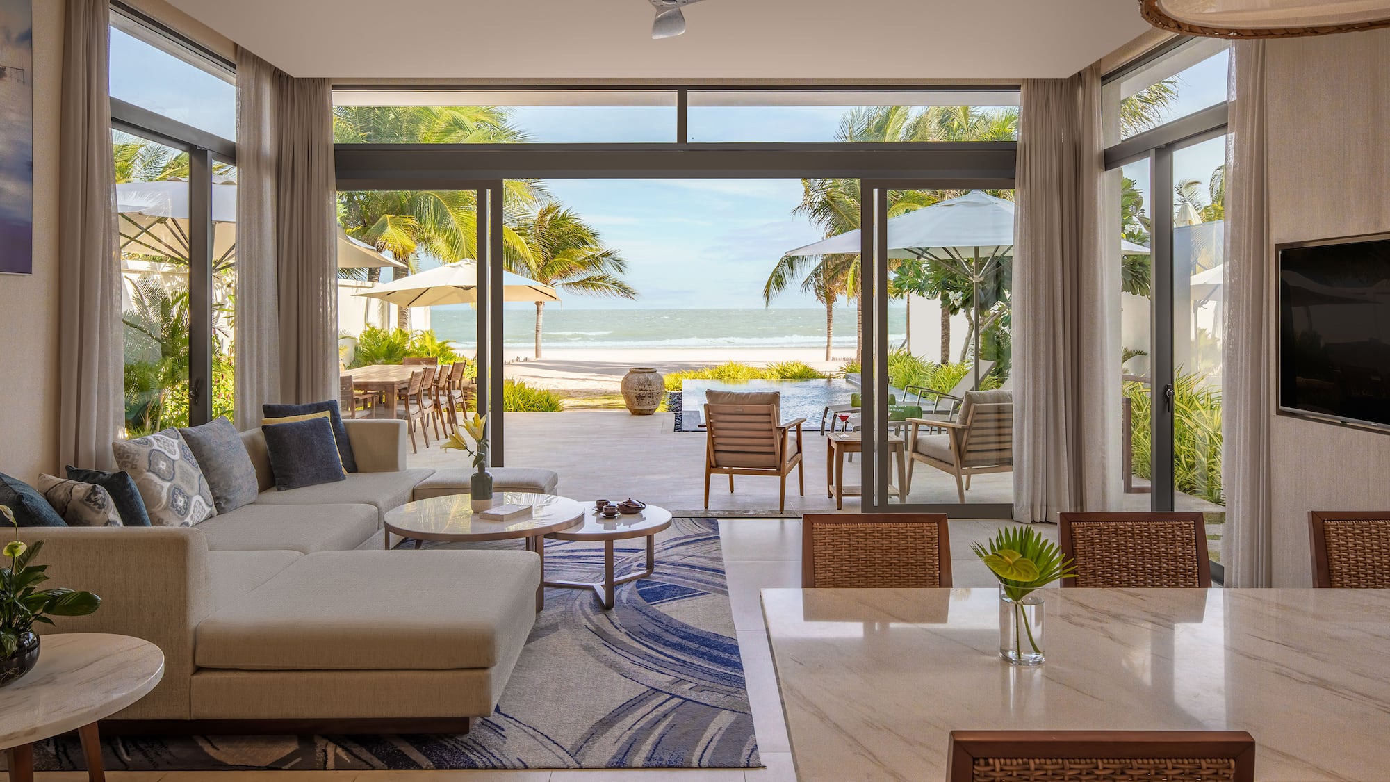 a living room with a large glass door and a large couch