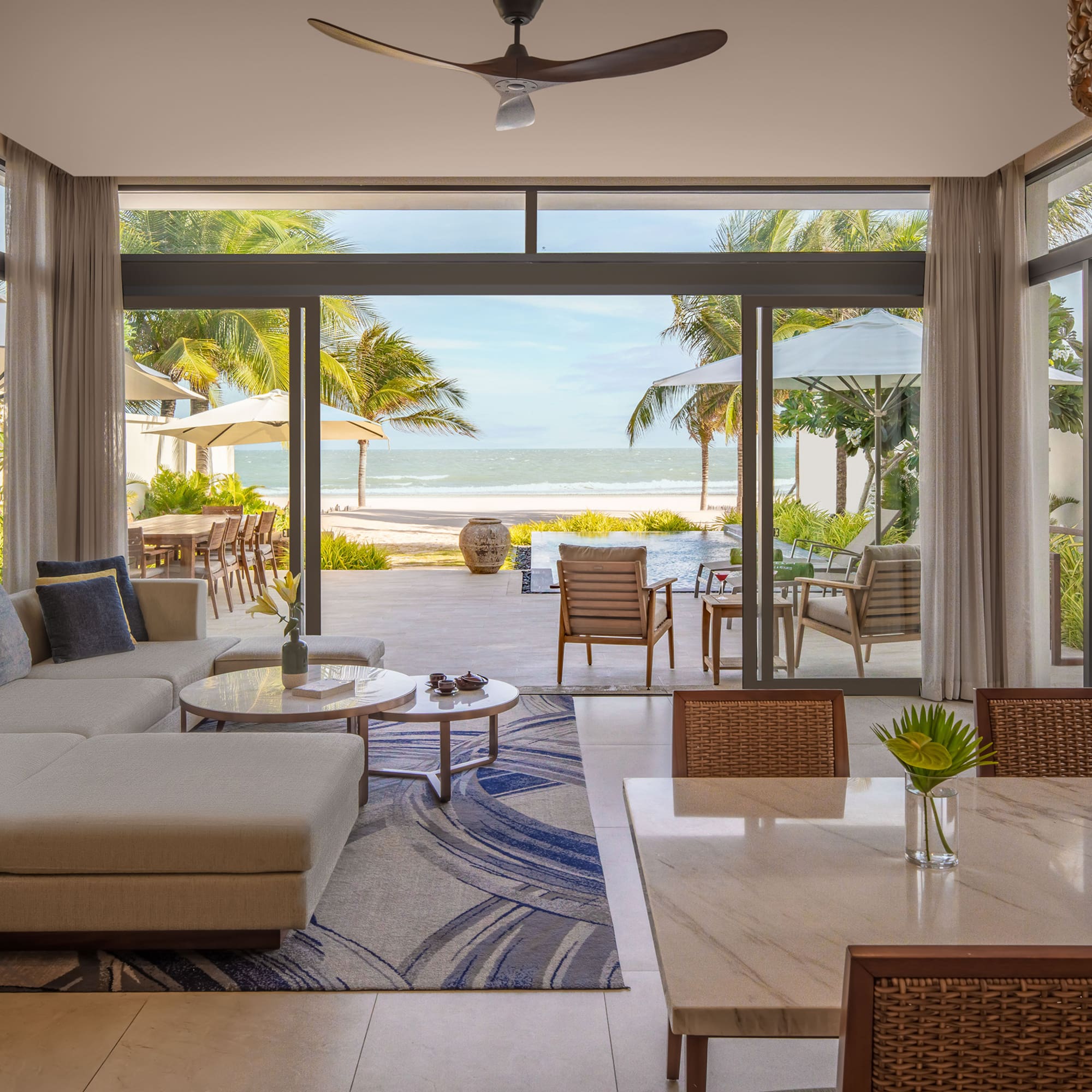 a living room with a large glass door and a large couch