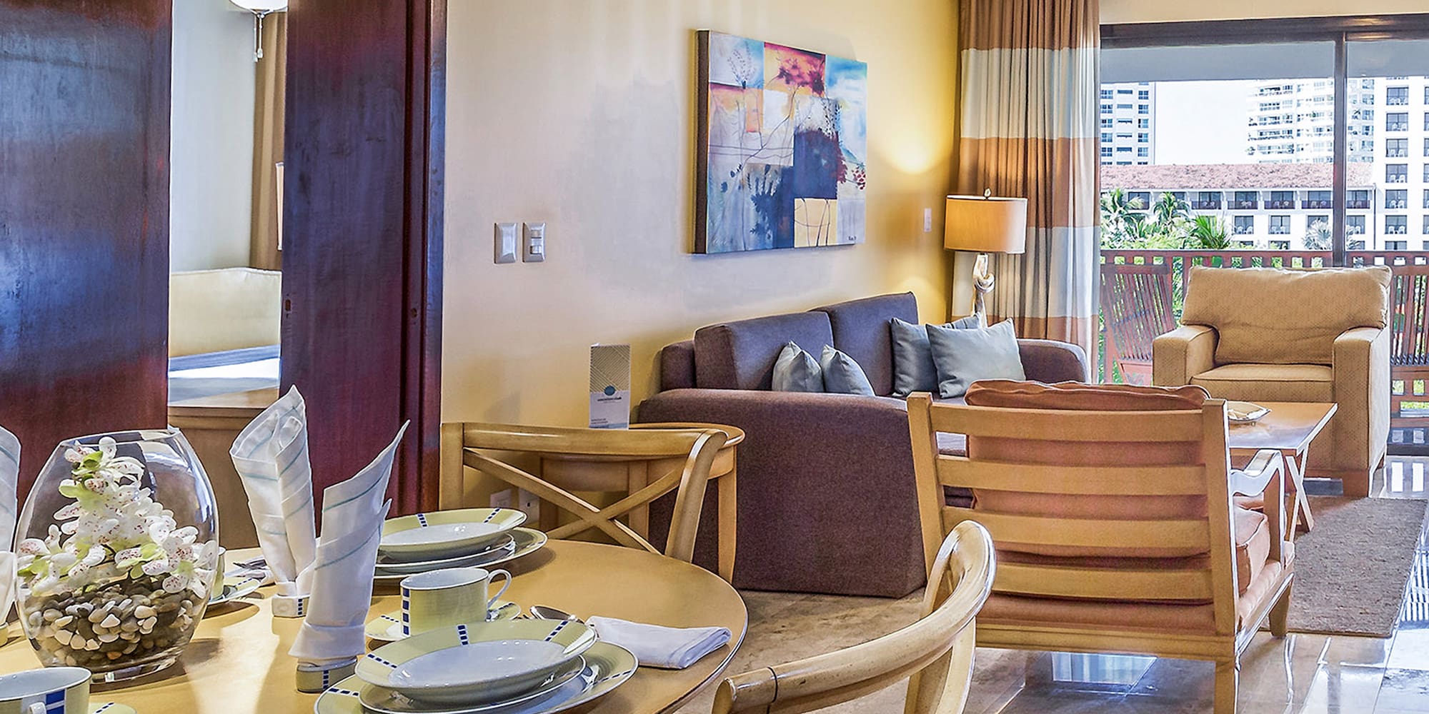 a living room with a table and chairs