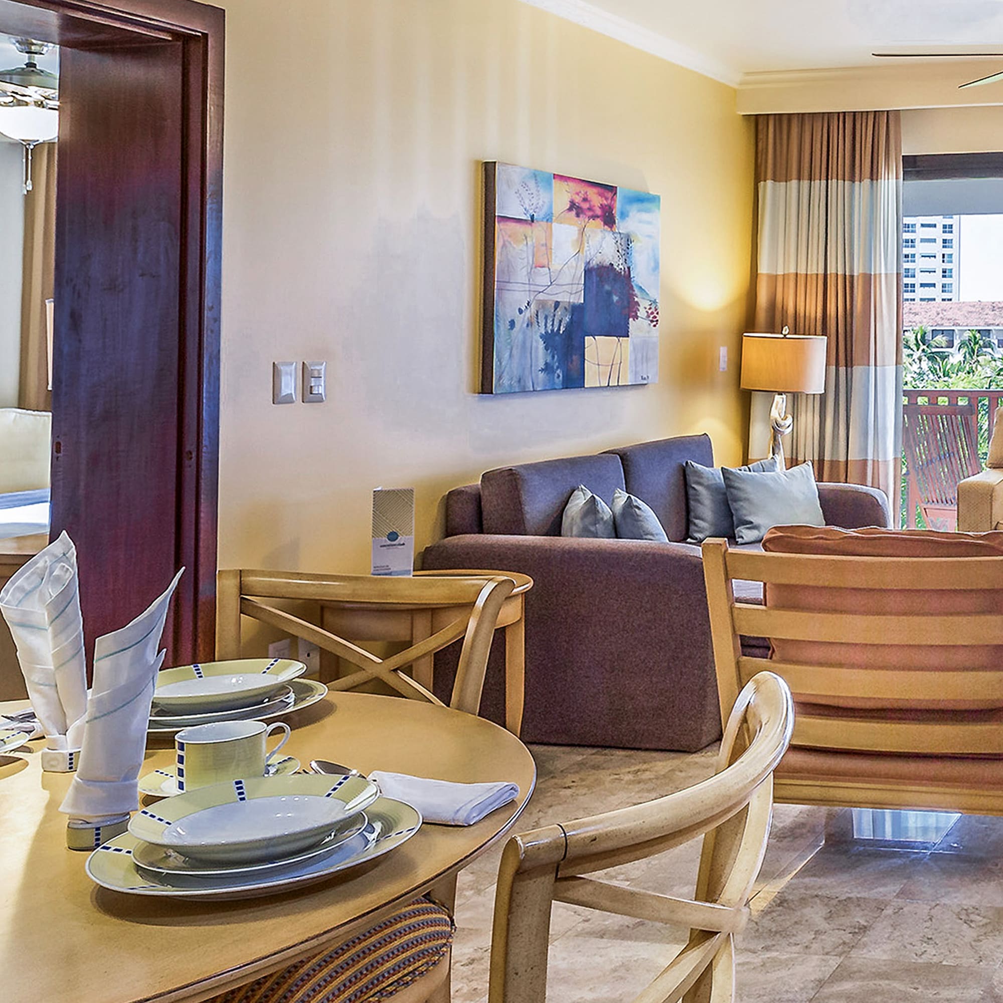 a living room with a table and chairs