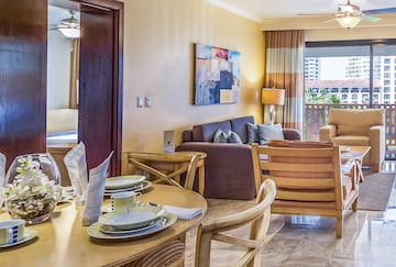 a living room with a table and chairs