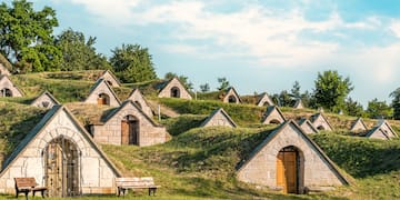 a group of stone buildings with grass on the ground