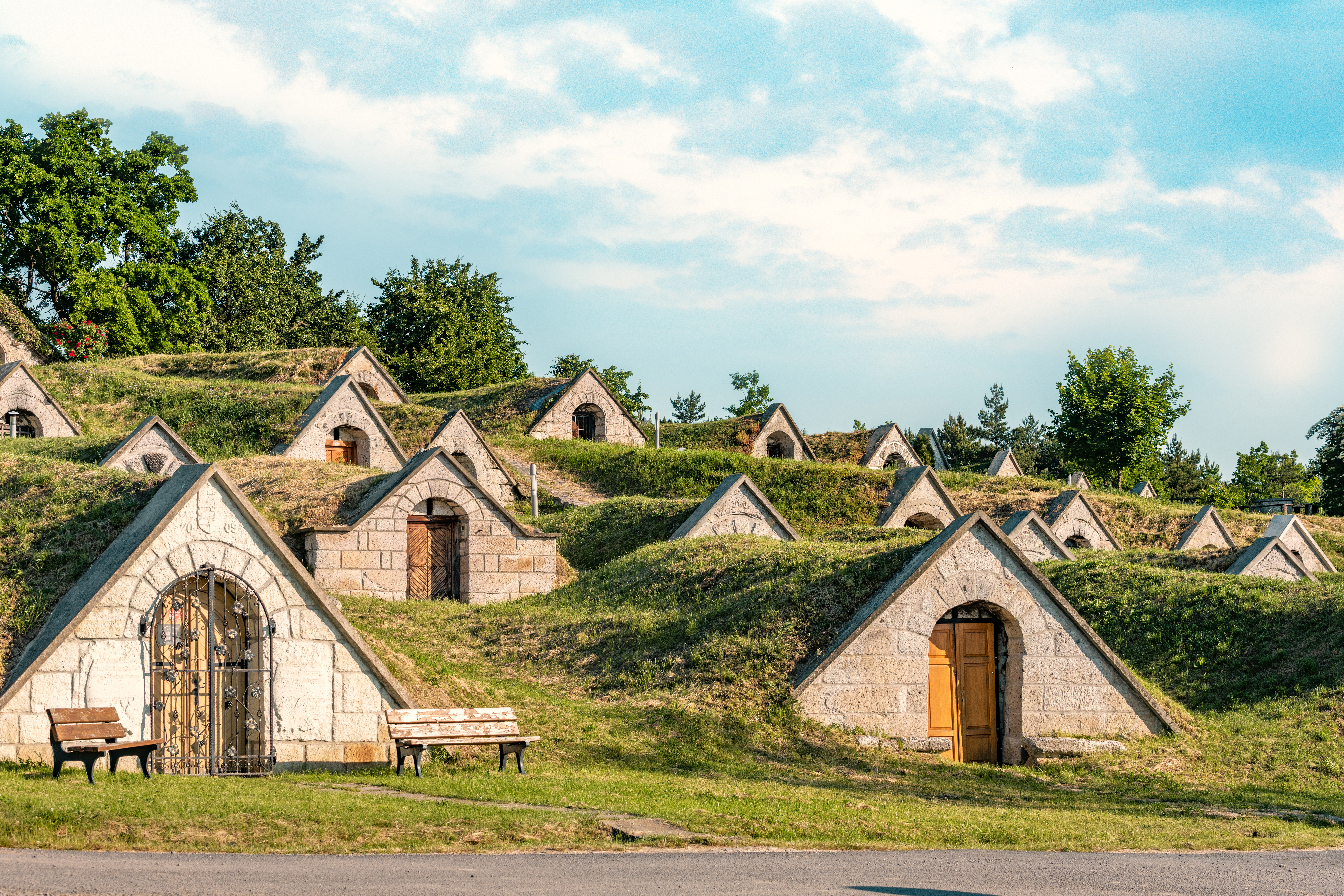 a group of stone buildings with grass on the ground