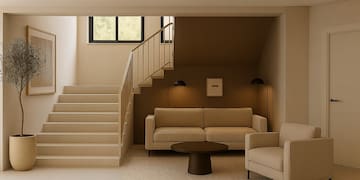 a living room with stairs and couches