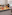 Hotel buffet with meats, cheeses, and fruits in a brightly lit dining room.