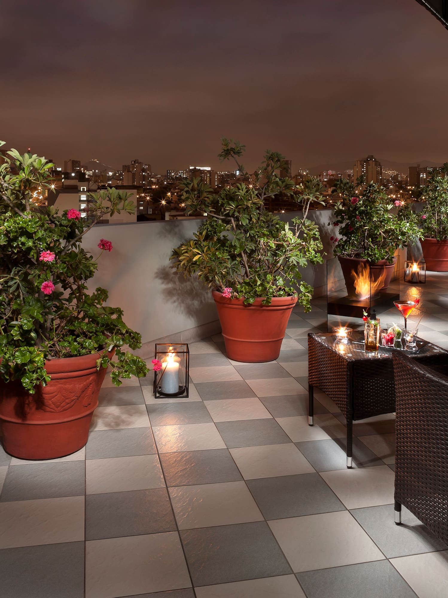 a patio with plants and candles on it