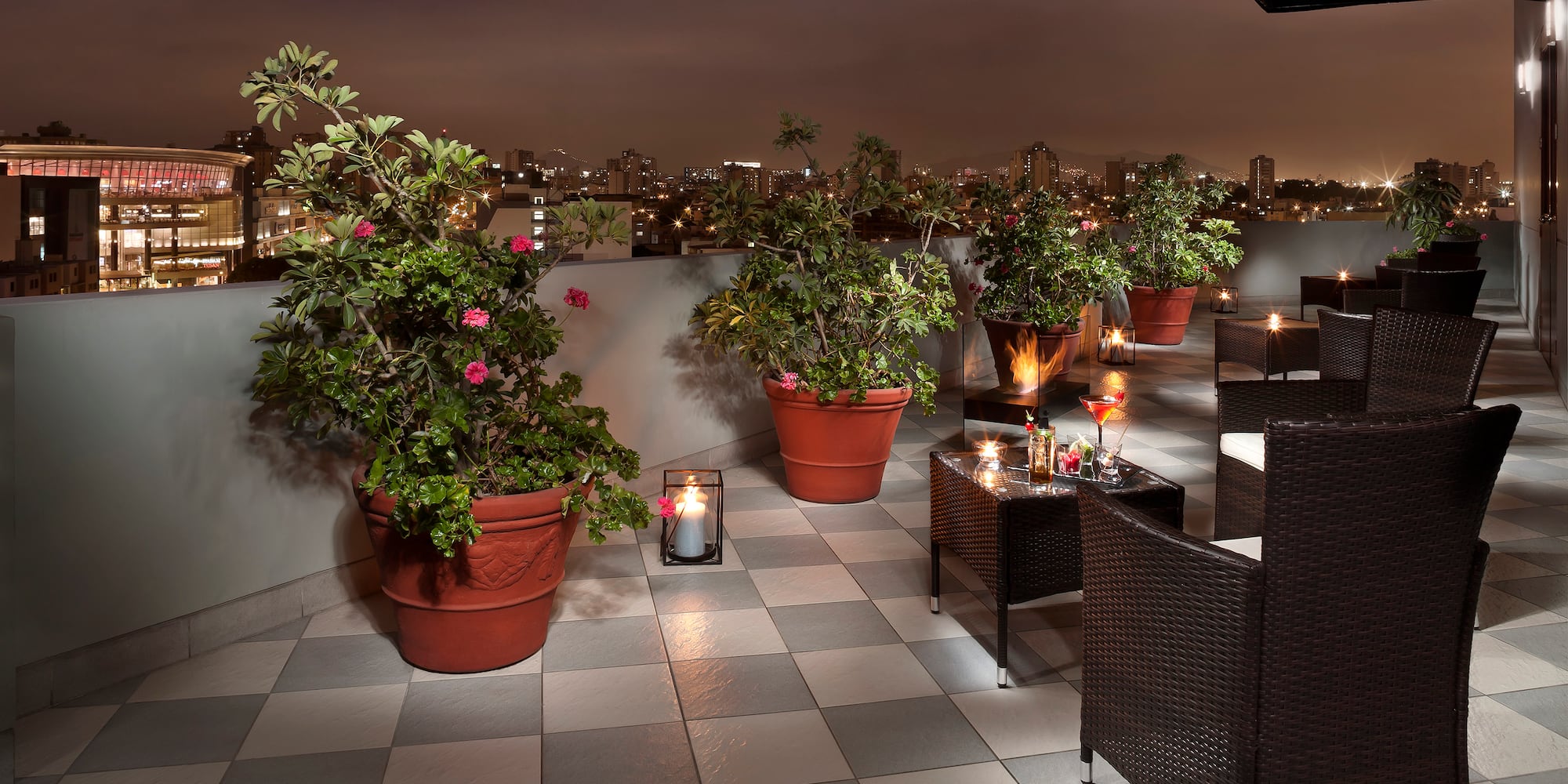 a patio with plants and candles on it