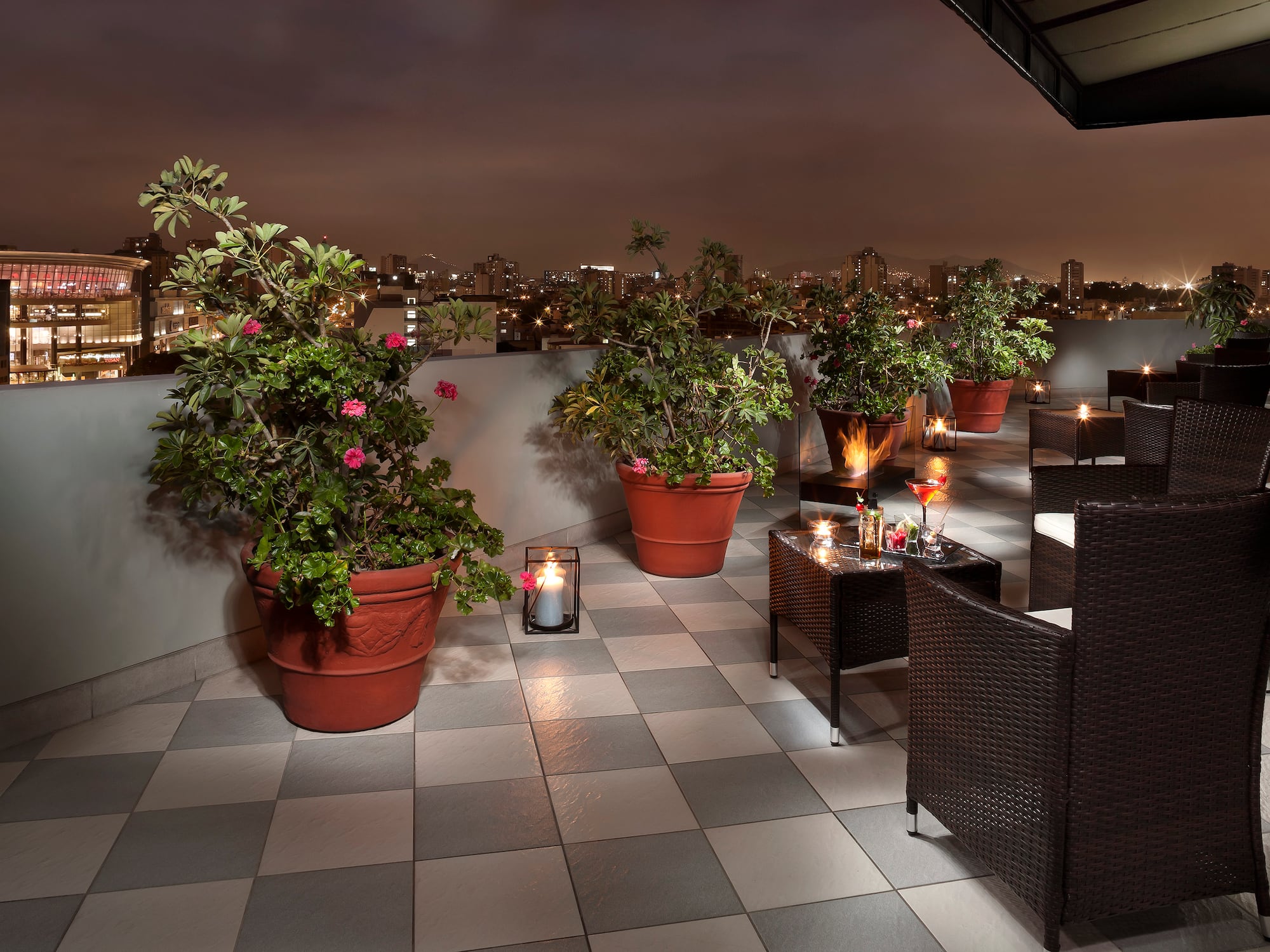 a patio with plants and candles on it