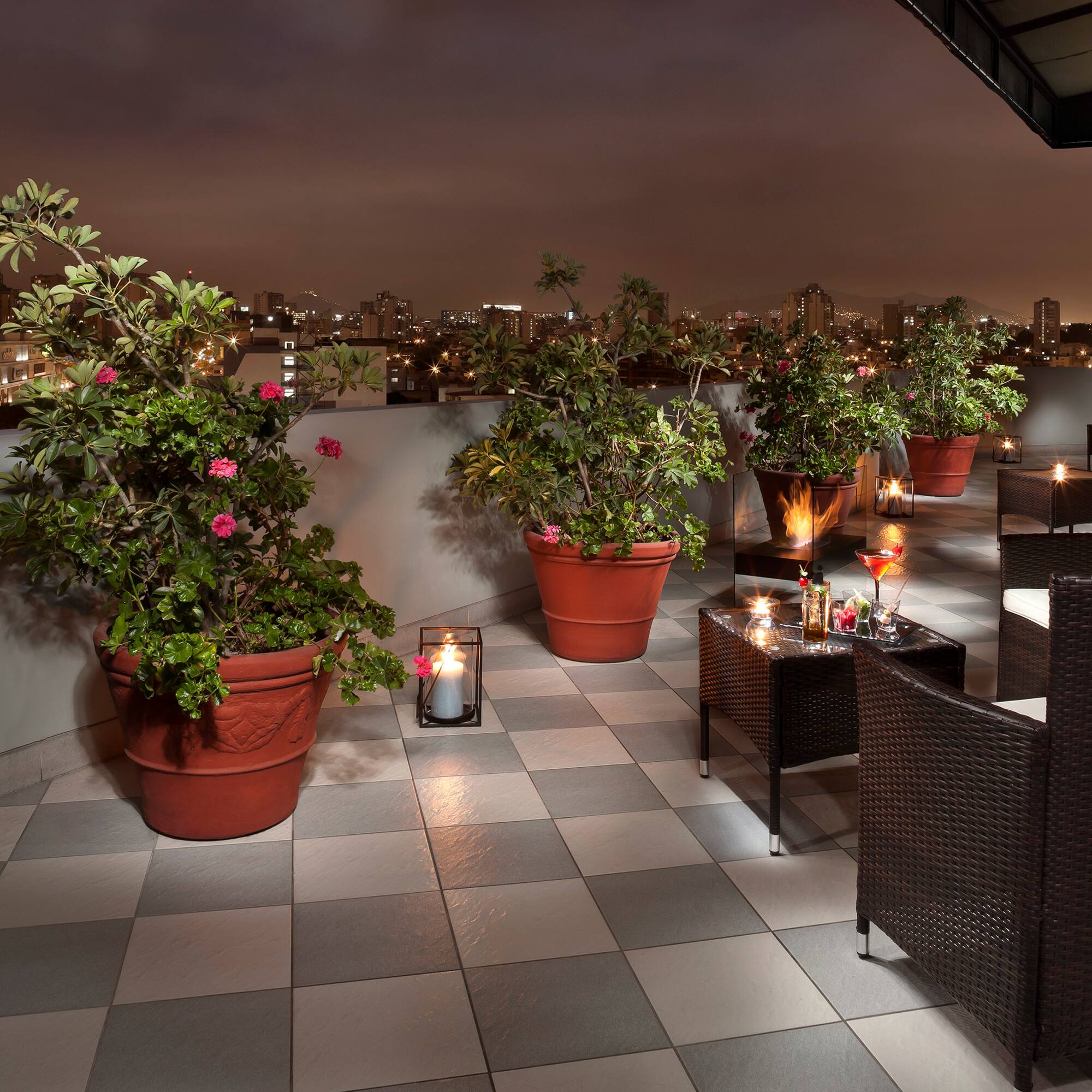 a patio with plants and candles on it